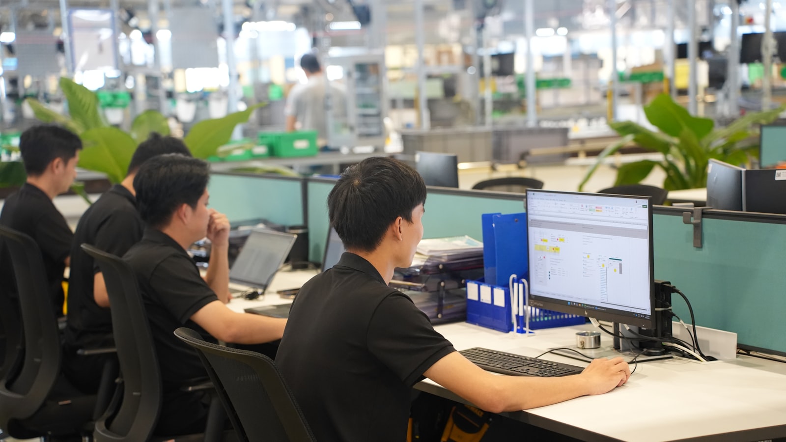 Workers at computers in a modern office setting